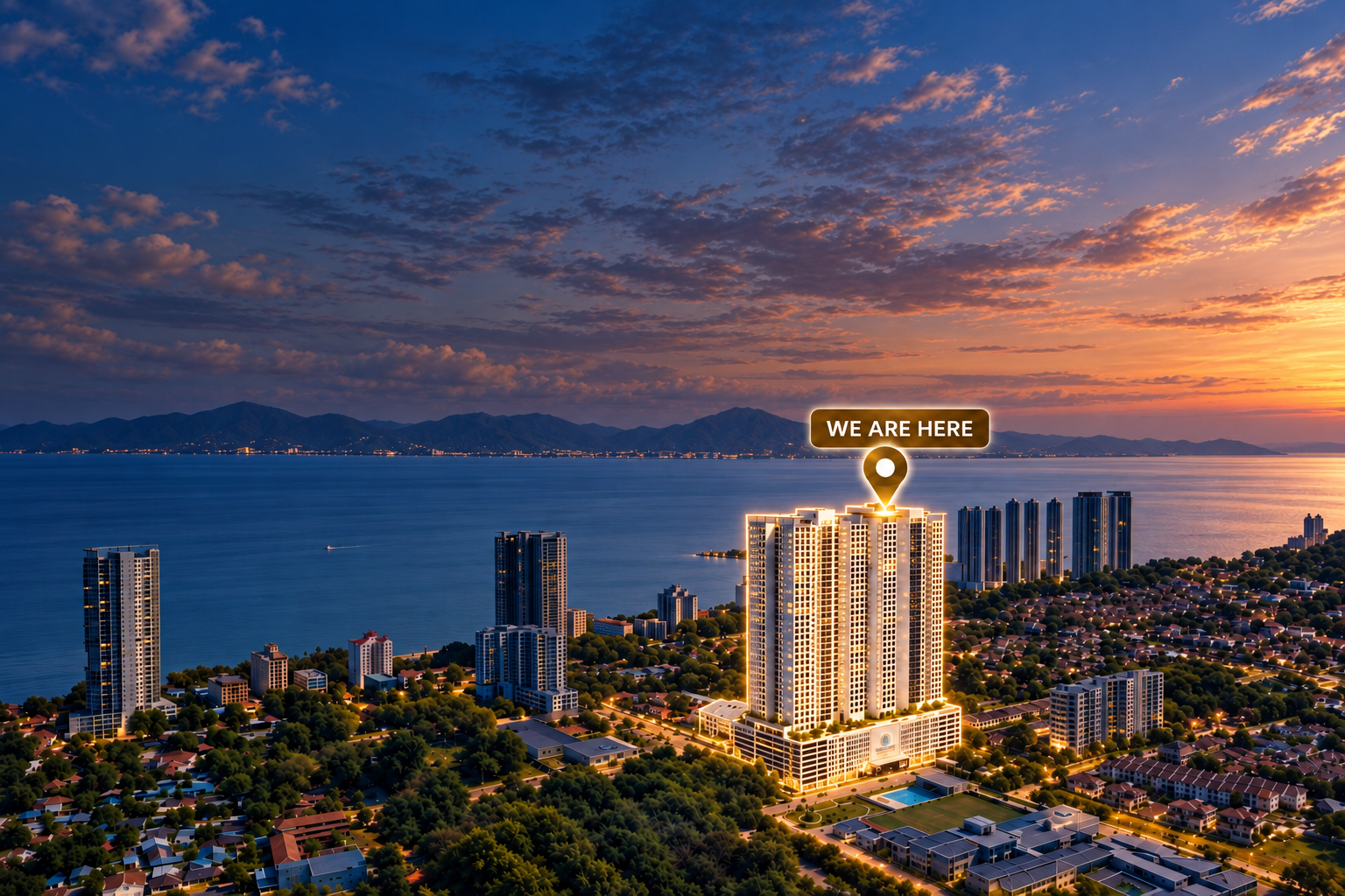 Waterstone twin towers highlighted in warm light within an aerial view of Tanjung Bungah